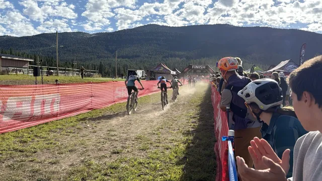 Teammates cheering on riders along the race course
