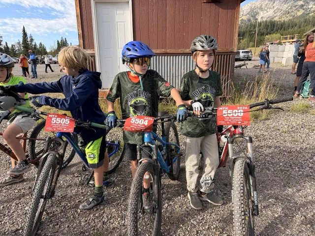 Young Dirt Dogz riders waiting with their bikes before a race